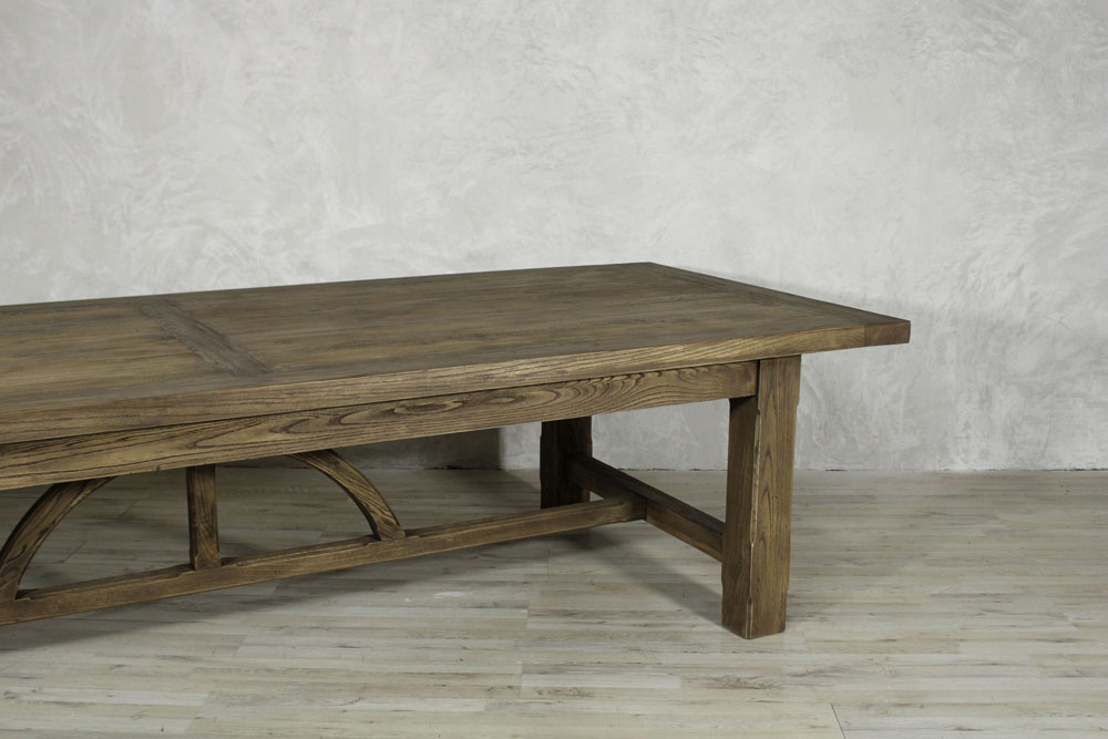 Arch Dining Table 1 Arch rectangular wooden dining table with sturdy square legs and curved support detailing.